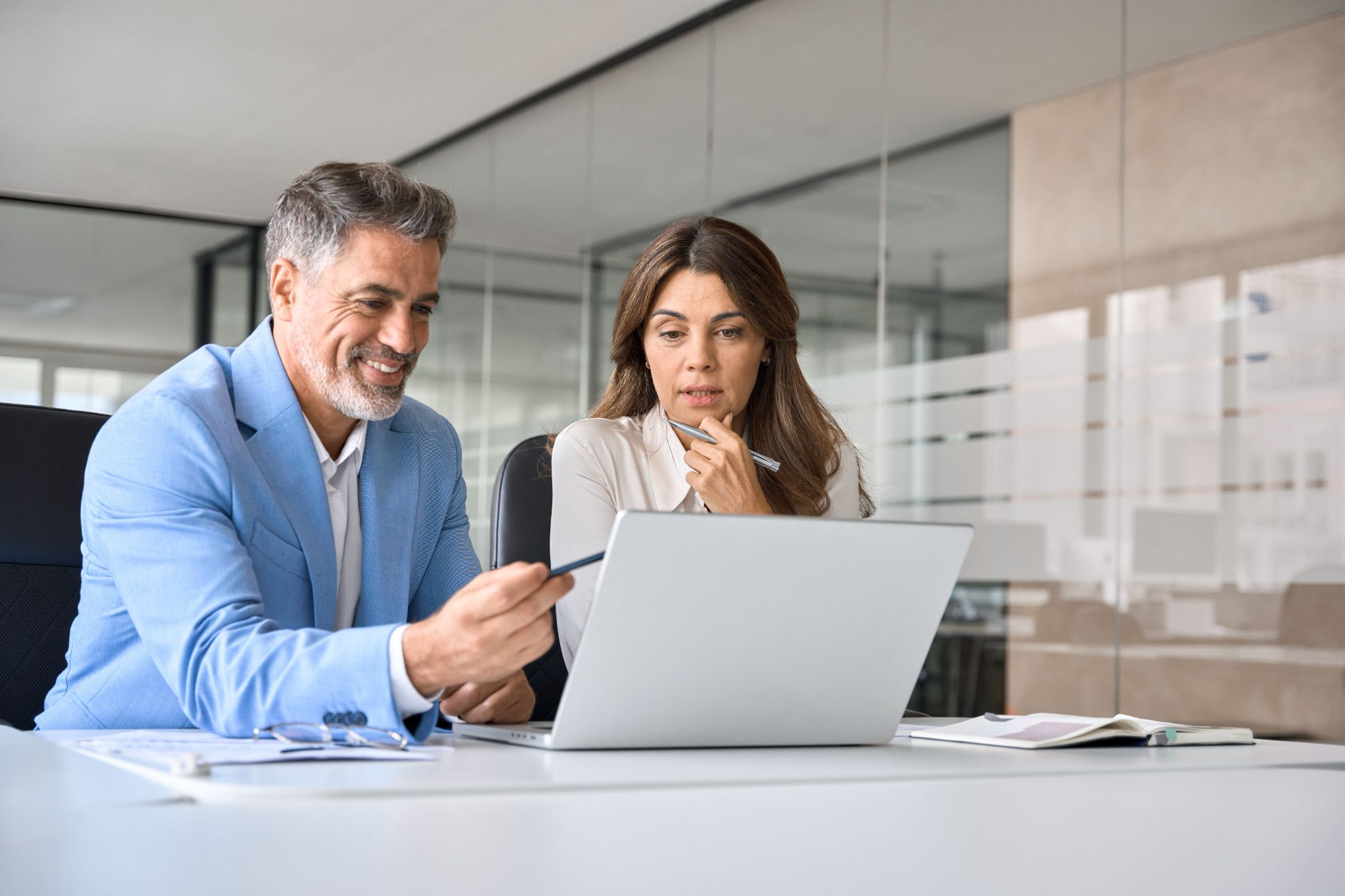 a man and a woman work at a computer